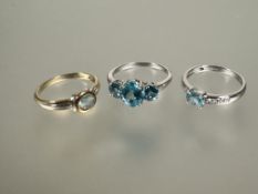 A silver ring set three graduated topaz coloured stones O/P 2.78g, a 9ct white gold oval topaz