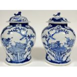 A pair of Chinese blue and white porcelain Kangxi-revival covered vases of baluster form, with panel