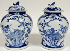 A pair of Chinese blue and white porcelain Kangxi-revival covered vases of baluster form, with panel