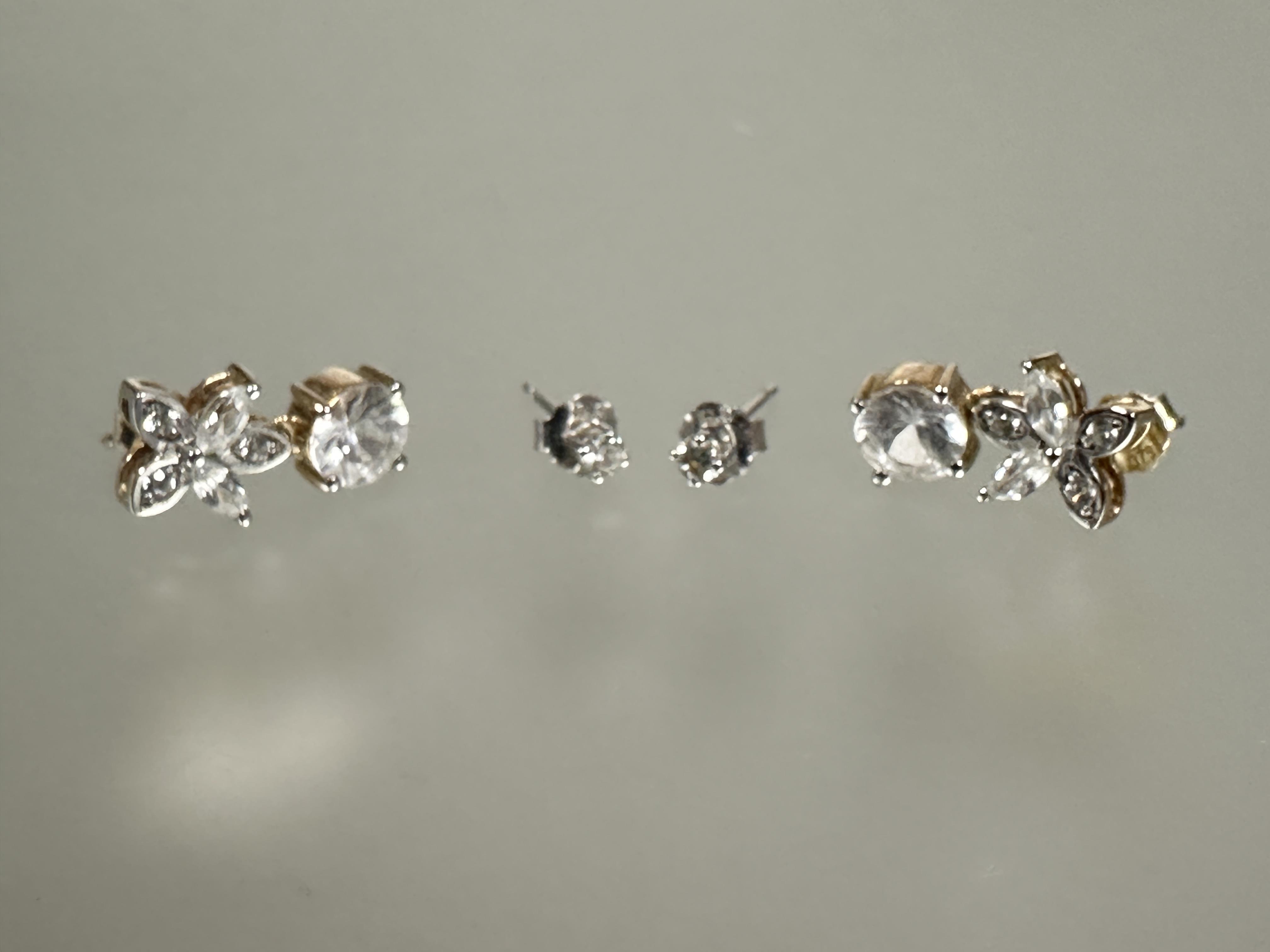 A pair of 9ct white gold set diamond stud earrings in claw setting approximately 0.05ct and a pair