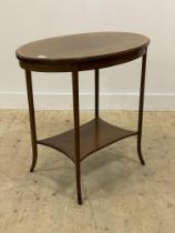 An Edwardian boxwood strung mahogany centre table of oval outline, the top raised on square
