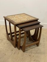 A G-Plan mid century teak nest of three tables, the larger inset with tiles. H51cm, W51cm.