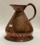 A 19th century copper 2 gallon pitcher with looped and riveted handle. H35cm.