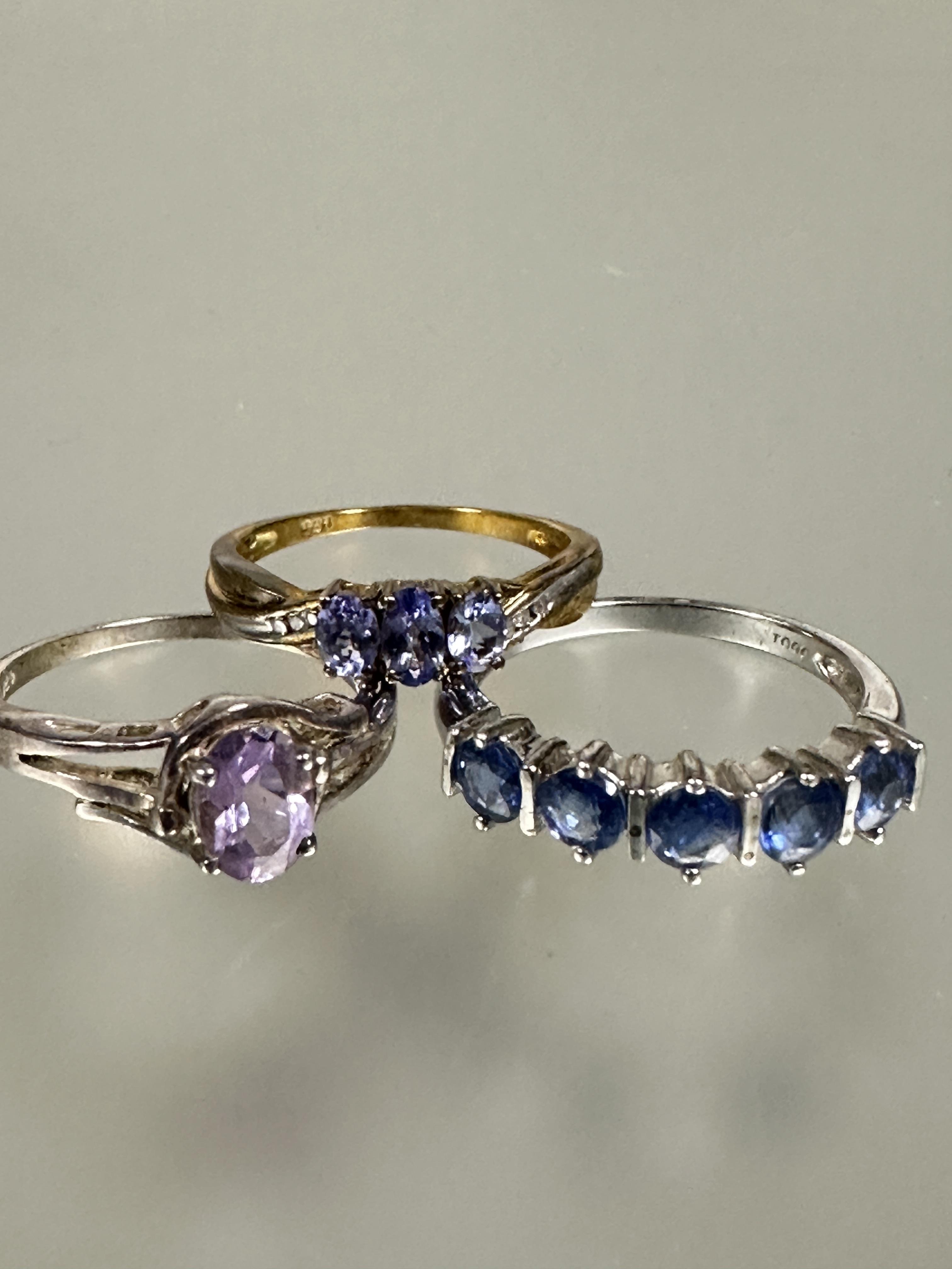 A group of five silver gem set rings including a amethyst colored cluster ring, a red three stone - Image 3 of 4