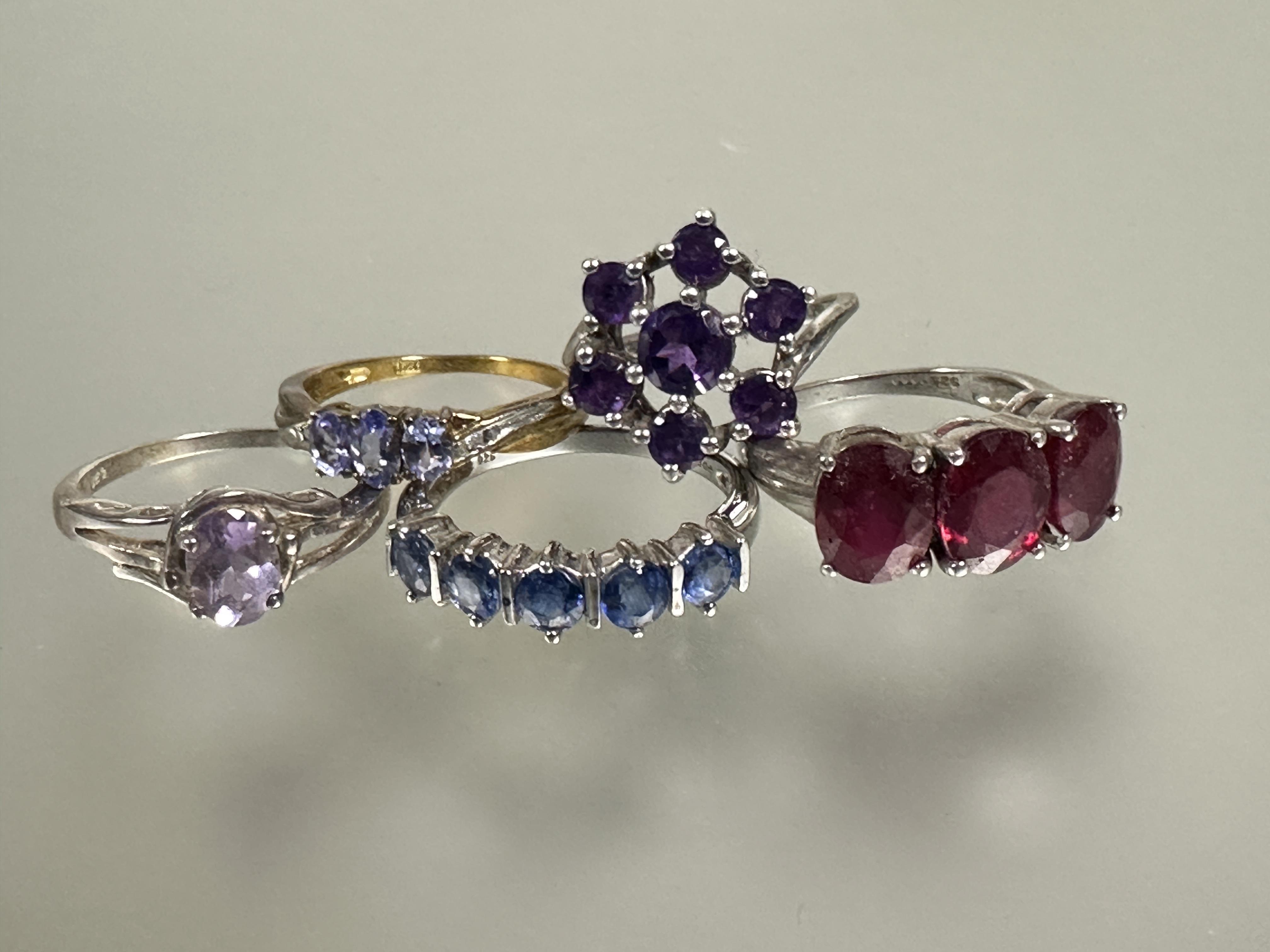 A group of five silver gem set rings including a amethyst colored cluster ring, a red three stone - Image 2 of 4