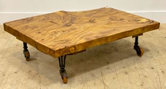 A bespoke live edge elm coffee table, the highly figured top raised on late 19th century cast iron