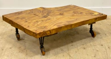 A bespoke live edge elm coffee table, the highly figured top raised on late 19th century cast iron
