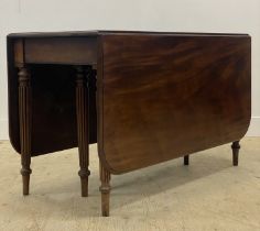 A Regency mahogany drop leaf dining table, the rectangular top with moulded edge raised on turned,