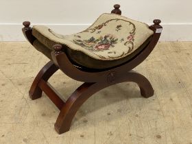 A stained oak 'x' frame stool with squab cushion and bulls eye roundel to frame. H45cm.