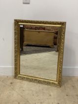 A traditional gilt composition wall hanging mirror with floral moulded frame. 67cm x 82cm.