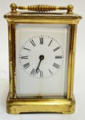 A lacquered brass carriage clock with enamelled dial and Roman numeral chapter ring (complete with