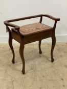 An Edwardian inlaid mahogany piano stool, with scrolled back and arm, hinged seat, raised on