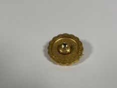 A late 19th century yellow metal target brooch, claw-set to the centre with a round-cut citrine,