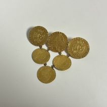 A large gold brooch formed of three George III full guineas and three George III half guineas, the