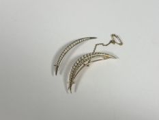 Two Victorian gold crescent brooches set with seed pearls: the larger with two rows of graduated