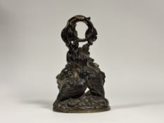 A late Victorian patinated brass door stop, cast as a pair of partridge beneath a leaf-cast