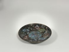 A Japanese cloisonne enamel dish in kyotojippo style, Meiji period, the central roundel depicting