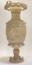 A 19th century carved alabaster urn, the flared rim with floral swags, above an acanthus and eagle
