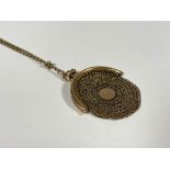 A lady's 9ct gold mesh change purse on chain, c. 1900, the oval purse on a tracelink chain