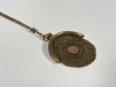 A lady's 9ct gold mesh change purse on chain, c. 1900, the oval purse on a tracelink chain