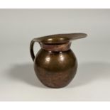 An Aesthetic movement copper ewer, third quarter 19th century, in the manner of Christopher Dresser,