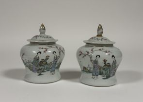 A pair of Chinese famille rose porcelain baluster jars and covers, c. 1900, each painted to the
