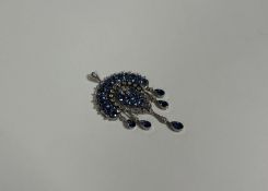A striking Edwardian sapphire and diamond pendant in the Indian taste, early 20th century, centred
