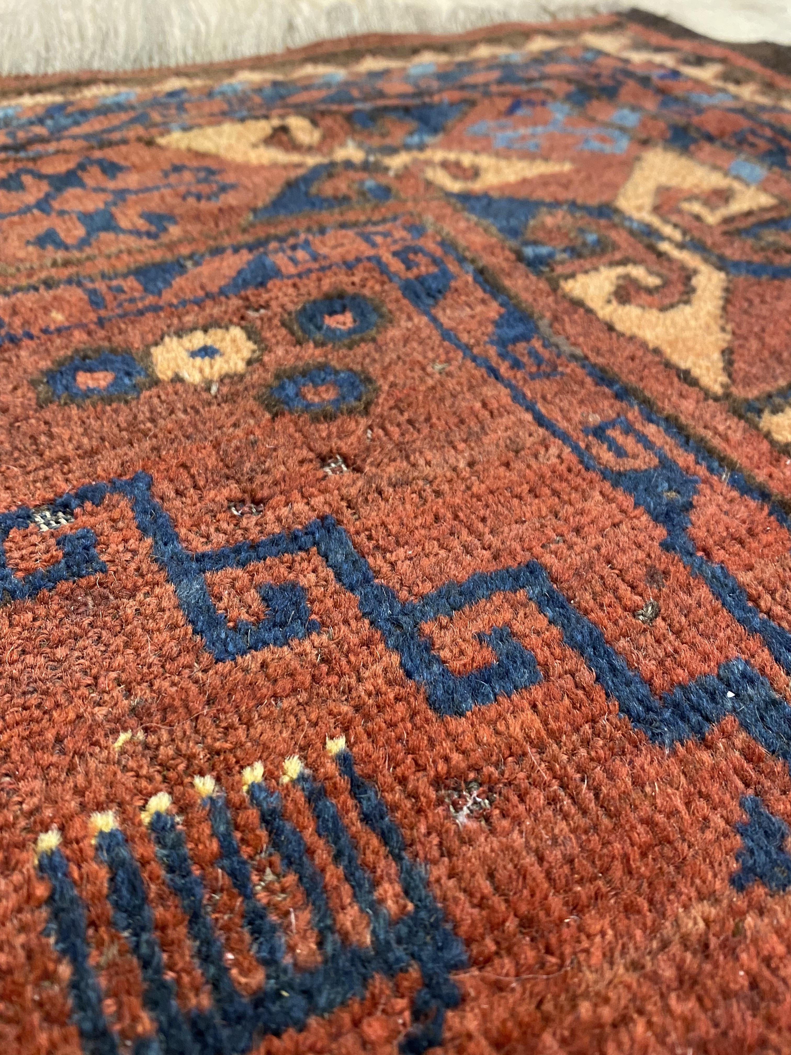 An Afghan Bokhara rug, first half of the 20th century, the red field with geometric motifs - Image 2 of 3