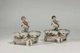 A pair of 19th century Berlin porcelain double table salts, in the Rococo taste, each with twin oval