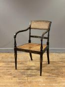 A Regency period ebonised open armchair, the crest rail with bergere panel, above a bar back painted
