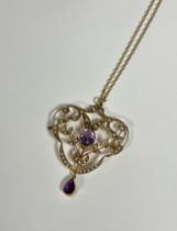 A 9ct gold amethyst and seed pearl pendant in the Edwardian taste, the pendant centred by an oval-