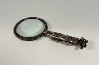 An unusual silver-plated desk magnifying glass of golfing interest, the handle modelled as a bag