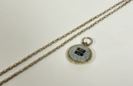 A late Victorian yellow metal (unmarked) and enamel mourning locket on chain, the circular hinged