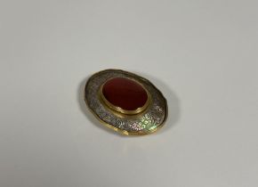 A gilt-metal mounted carved abalone shell snuff box, 18th/19th century, the hinged cover formed from