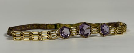 A three-stone amethyst choker, early 20th century, the graduated hexagonal-cut stones claw- and