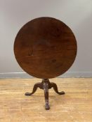 A George III mahogany tilt-top tripod table, the single-plank circular top above a bird-cage