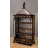 A Chinese Straits / Peranakan display cabinet, circa 1910 - 1920, with carved pagoda and figural