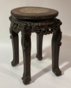 A late Qing dynasty Chinese rosewood jardinière stand, the circular top with beaded moulding to edge