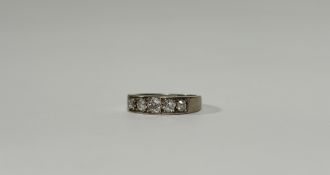 A five-stone diamond ring, the graduated round brilliant-cut stones channel set in an 18ct yellow