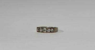 A five-stone diamond ring, the graduated round brilliant-cut stones channel set in an 18ct yellow