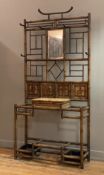 An Aesthetic movement hall stand, late 19th century, the bamboo frame with six coat hooks