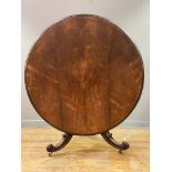 A mid Victorian rosewood centre table, the circular tilt-top with moulded edge above a faceted