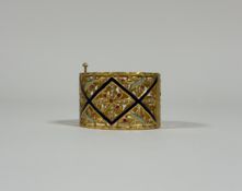 A striking hinged yellow metal bangle (possibly high carat gold, unmarked and untested), trellis-