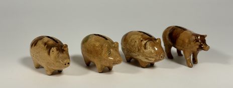 A group of four Scottish glazed pottery pig money banks, 19th century, of similar form, each with