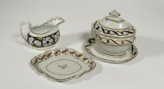 A New Hall porcelain sauce tureen on stand, early 19th century, of oval bellied form, decorated with