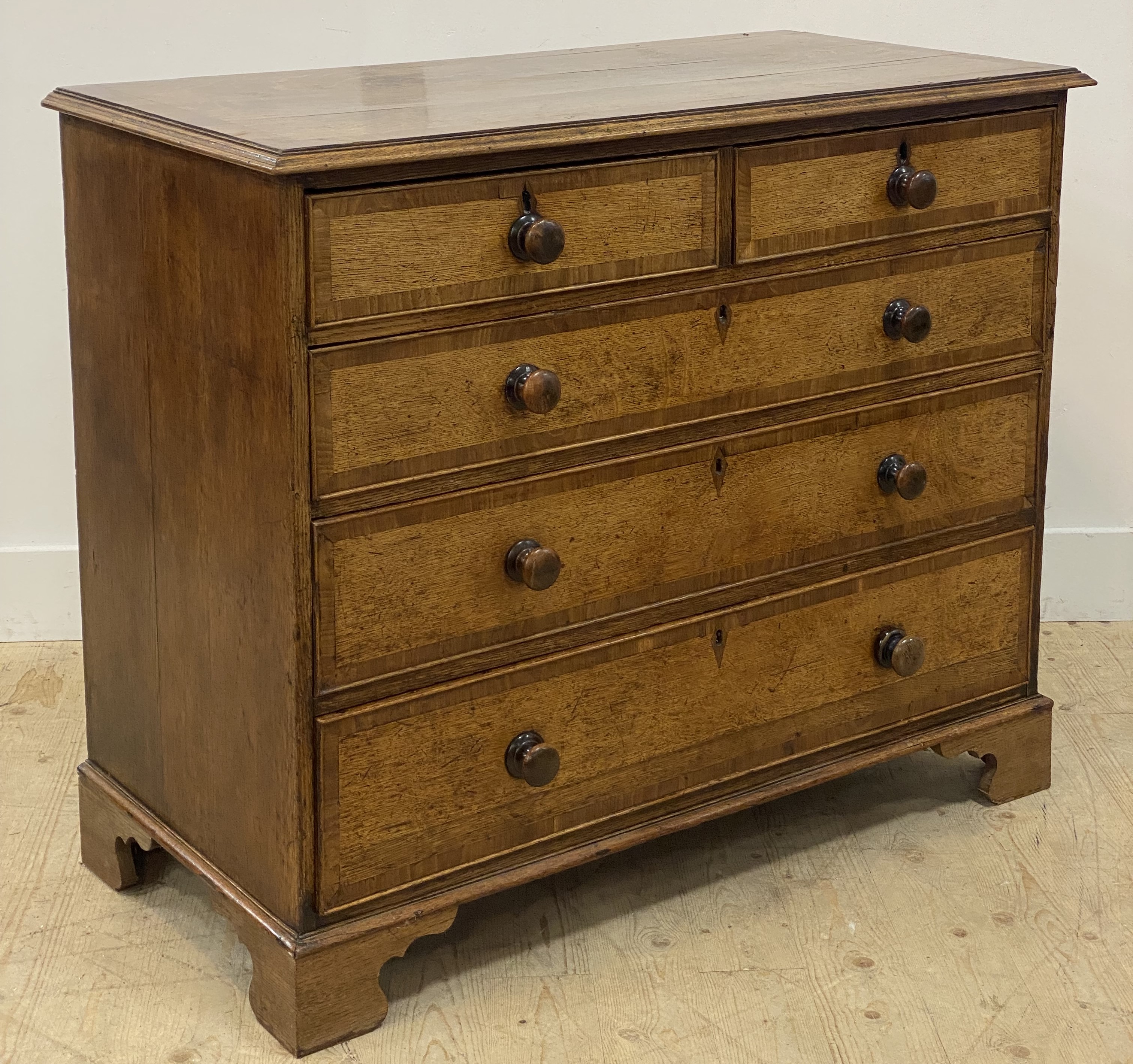 A country Georgian oak chest, late 18th century, the mahogany cross-banded top above two short and - Image 2 of 3