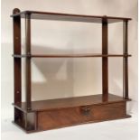 A late 19th century mahogany three-height wall rack, with ring-turned and brass spindle supports and