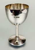 A modern Britannia standard silver goblet with planished finish or turned column and domed