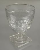 A large regency crystal slice cut rummer with festoon and swag design on square slice cut base small