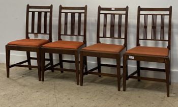 A set of four George III mahogany dining chairs, with drop in seat pads, raised on square tapered